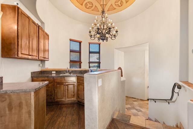 interior details featuring coffered ceiling, ceiling fan with notable chandelier, and beamed ceiling