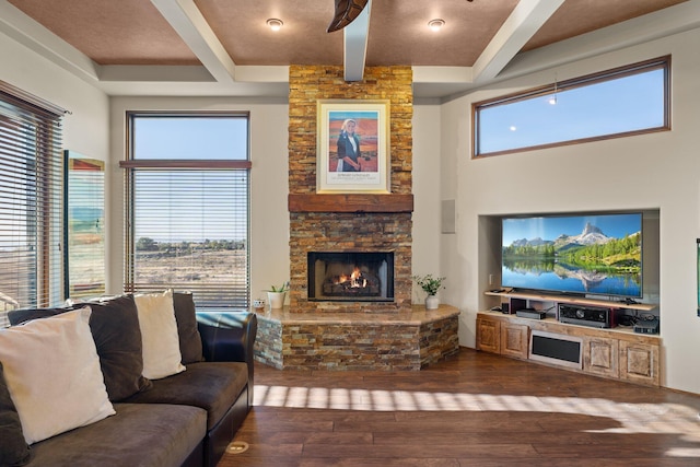 living room featuring a high ceiling, coffered ceiling, dark hardwood / wood-style flooring, and a fireplace