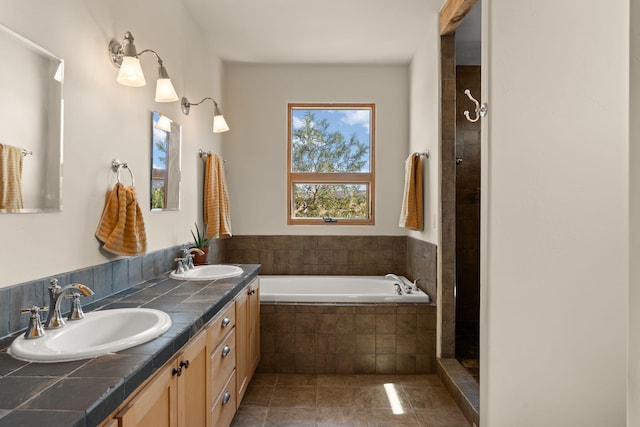 bathroom featuring independent shower and bath, tile patterned flooring, and vanity