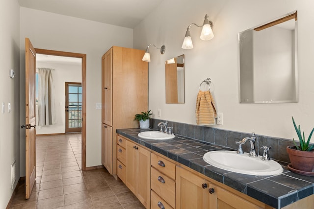 bathroom with tile patterned flooring and vanity