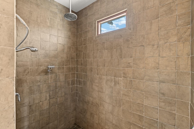 bathroom with a tile shower