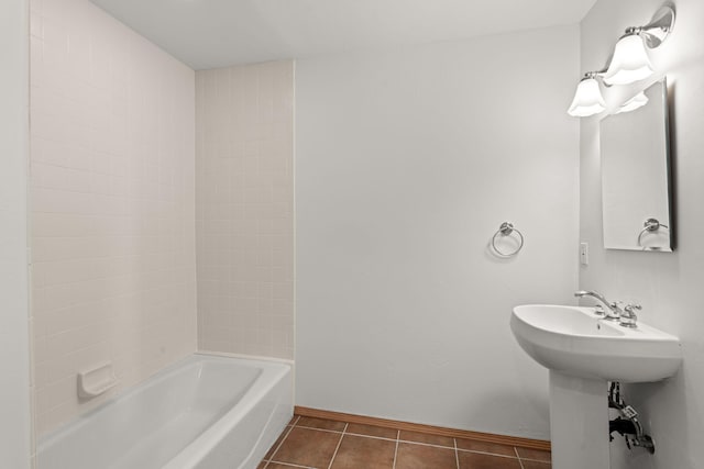 bathroom with sink, bathing tub / shower combination, and tile patterned flooring