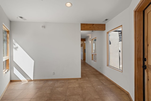 hall with light tile patterned floors