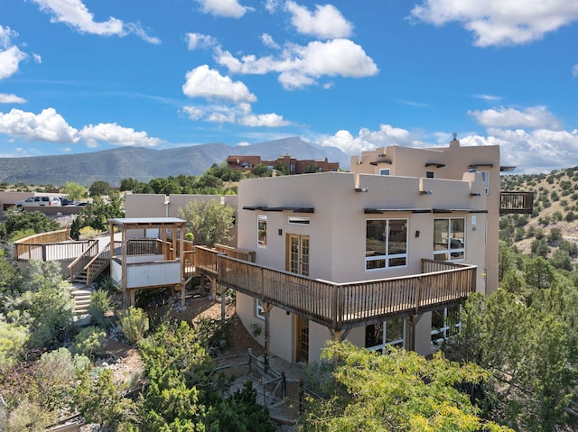 rear view of property with a deck with mountain view