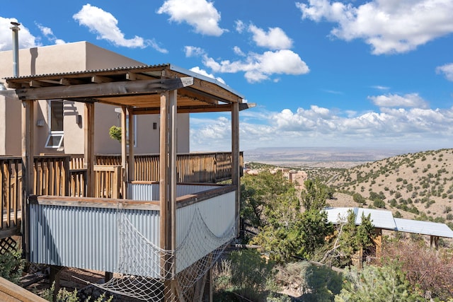 deck with a pergola and a mountain view