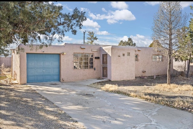 pueblo-style home with a garage