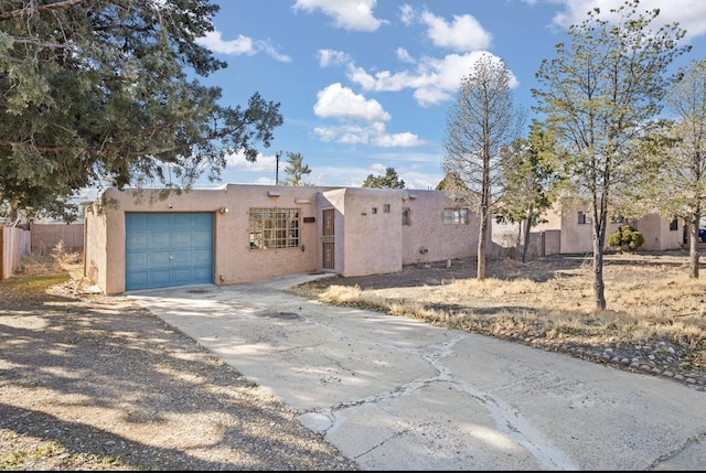 pueblo-style house with a garage