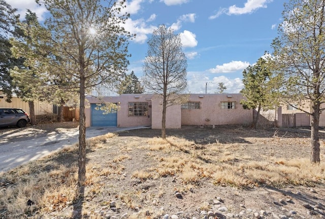 pueblo-style house with a garage