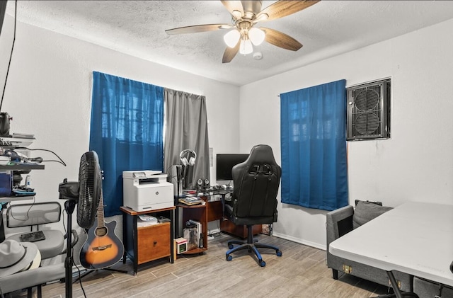 office featuring ceiling fan, a textured ceiling, and light hardwood / wood-style flooring