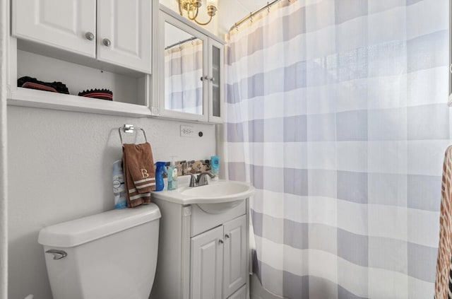 bathroom featuring toilet and vanity