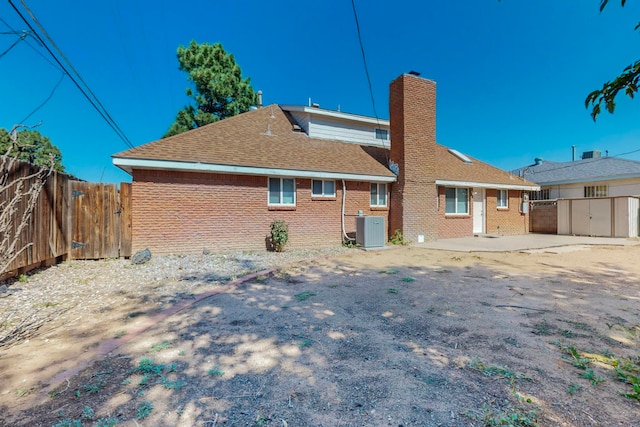 back of property with a patio and central AC