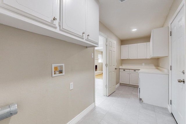 kitchen with light tile patterned floors, visible vents, white cabinetry, baseboards, and light countertops