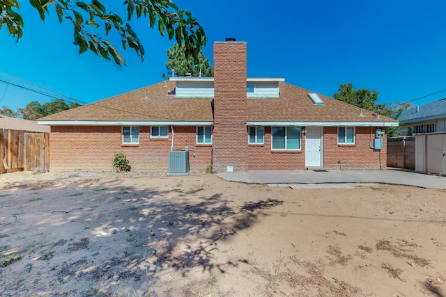 rear view of house featuring central air condition unit