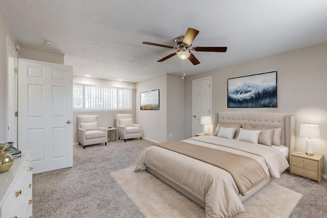 bedroom featuring carpet floors, ceiling fan, and a textured ceiling