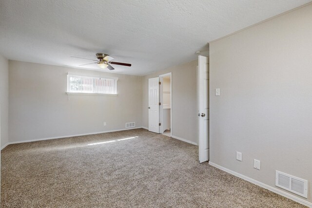 bathroom with a textured ceiling, vanity, and toilet