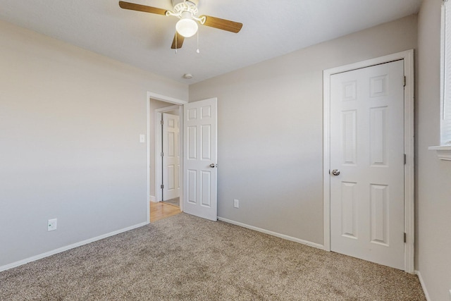 unfurnished bedroom featuring a ceiling fan, carpet flooring, and baseboards