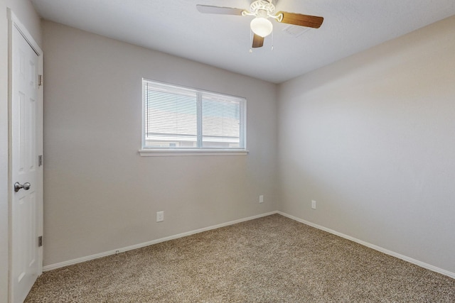 empty room with carpet floors, ceiling fan, and baseboards