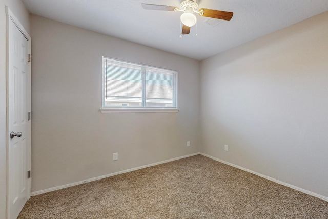 carpeted spare room with ceiling fan