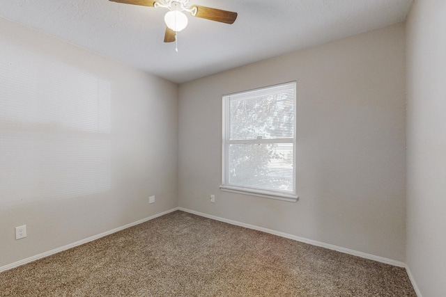 empty room with ceiling fan, carpet flooring, and baseboards