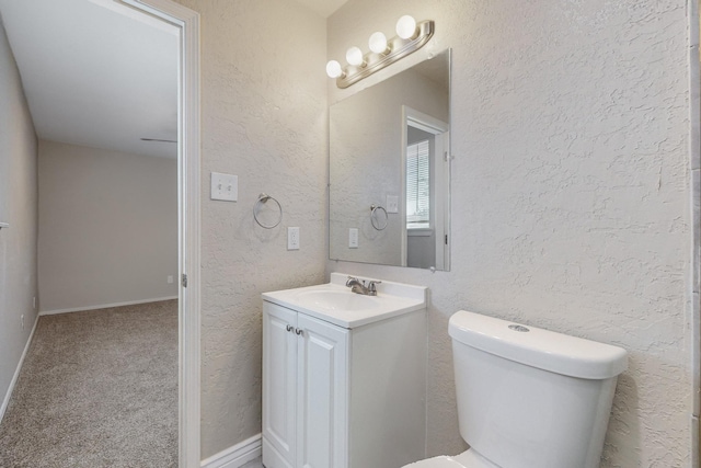 bathroom featuring toilet and a textured wall