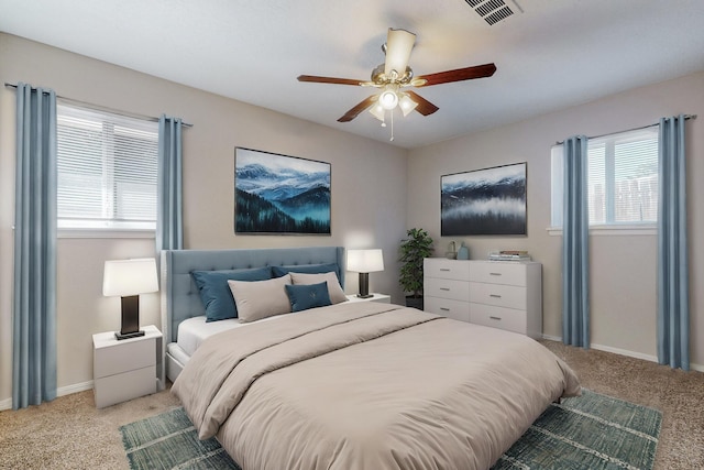 bedroom featuring light carpet, a ceiling fan, visible vents, and baseboards