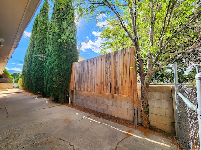 view of gate featuring a patio