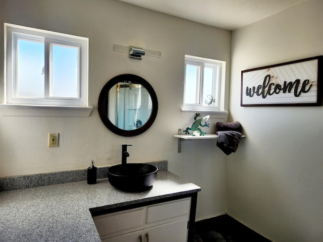 bathroom with plenty of natural light and vanity