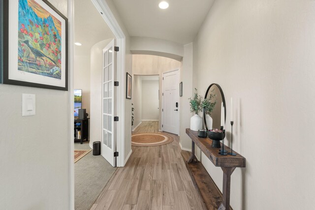 hallway with wood-type flooring