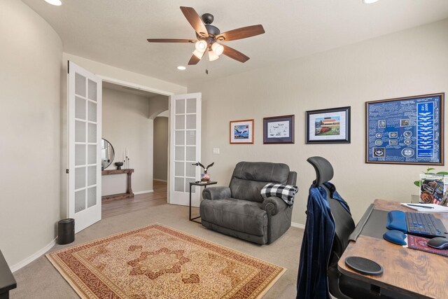 home office with french doors, carpet flooring, and ceiling fan