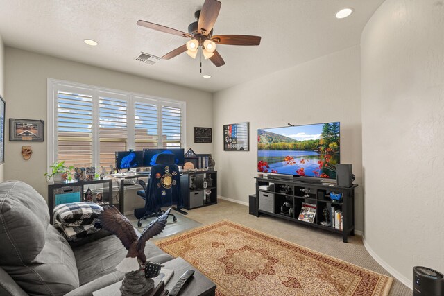 home office featuring light colored carpet and ceiling fan