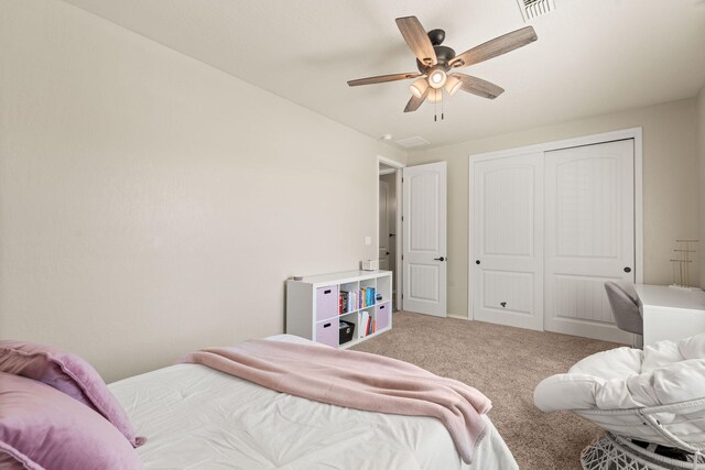 carpeted bedroom featuring a closet and ceiling fan