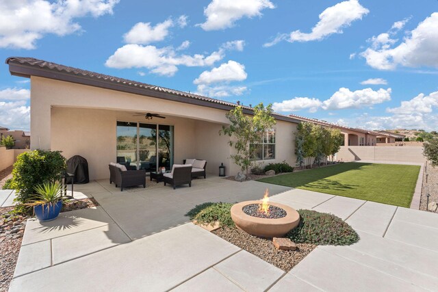 back of house featuring a patio, an outdoor living space with a fire pit, a lawn, and ceiling fan