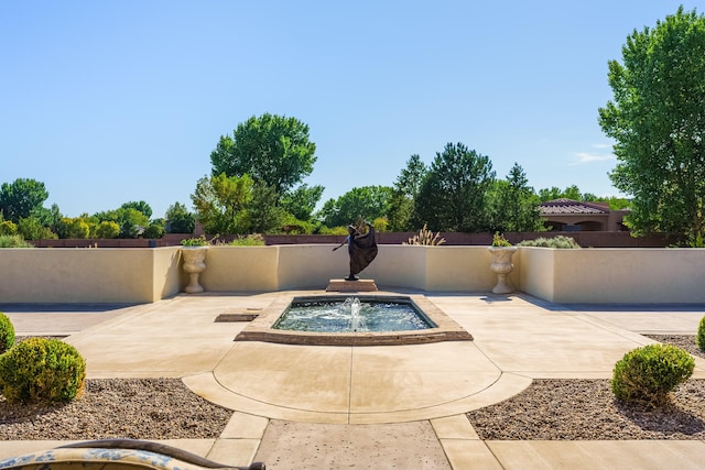 view of swimming pool with pool water feature