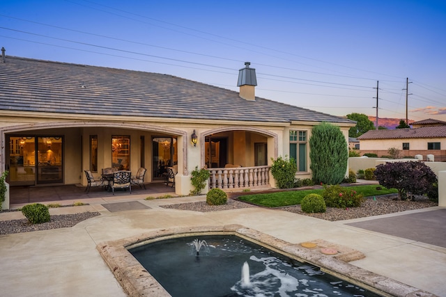 back of property with a patio