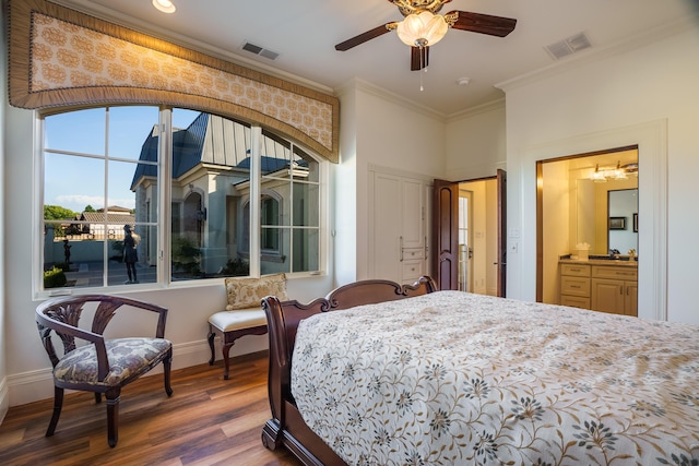 bedroom featuring hardwood / wood-style floors, ceiling fan with notable chandelier, crown molding, and sink