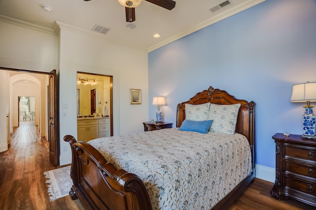 bedroom featuring ceiling fan, dark hardwood / wood-style floors, ornamental molding, and ensuite bath