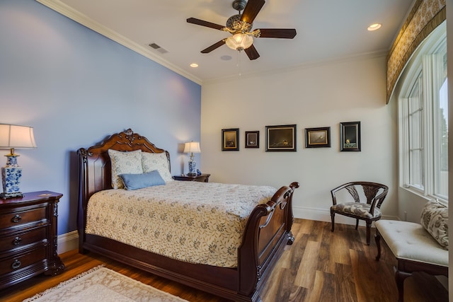 bedroom with hardwood / wood-style floors, ceiling fan, and crown molding