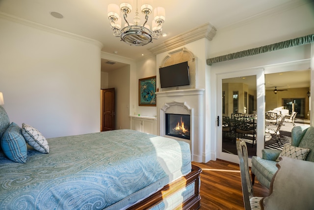 bedroom with dark hardwood / wood-style floors, a notable chandelier, and ornamental molding