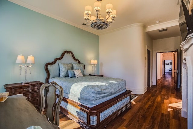 bedroom with dark hardwood / wood-style flooring, ornamental molding, and a notable chandelier