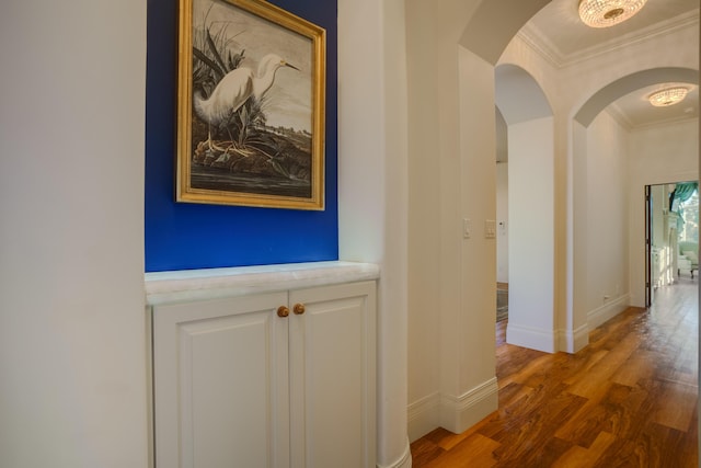 corridor featuring dark hardwood / wood-style flooring and ornamental molding