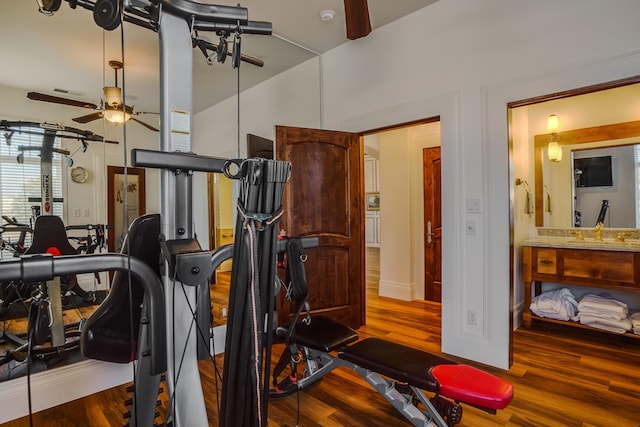 exercise area featuring ceiling fan and wood-type flooring