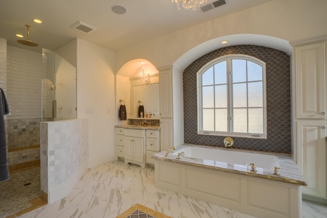 bathroom featuring a chandelier, vanity, and independent shower and bath