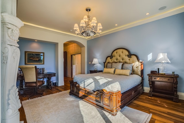 bedroom with an inviting chandelier, dark hardwood / wood-style floors, and ornamental molding