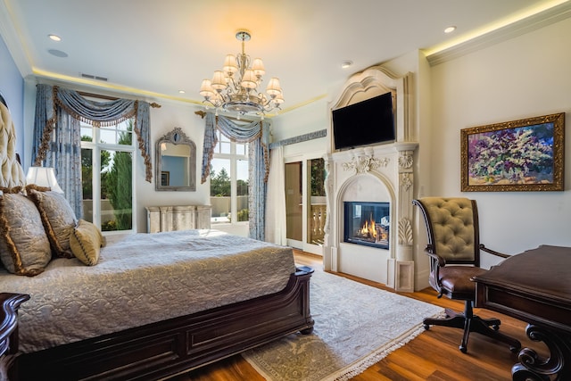 bedroom featuring crown molding, a notable chandelier, and hardwood / wood-style flooring