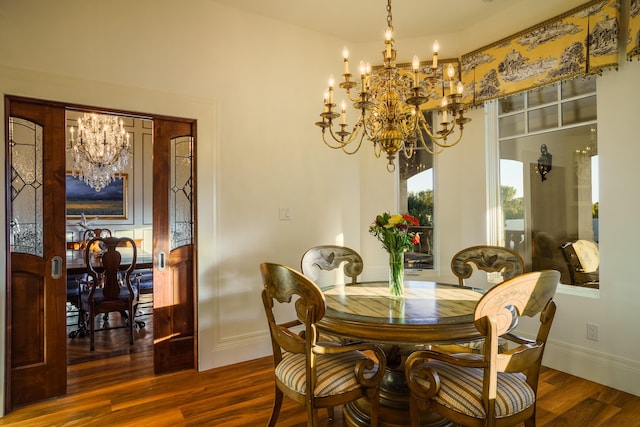 dining room featuring a notable chandelier and dark hardwood / wood-style flooring