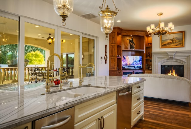 kitchen with sink, stainless steel dishwasher, ceiling fan, light stone countertops, and decorative light fixtures