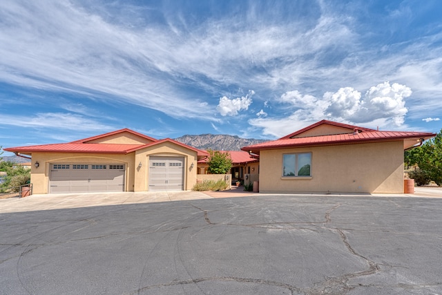 view of front of home with a mountain view and a garage