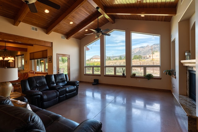 living room featuring a mountain view, wood ceiling, ceiling fan, and a high end fireplace