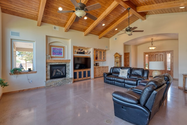 living room with beamed ceiling, high vaulted ceiling, wooden ceiling, and a stone fireplace