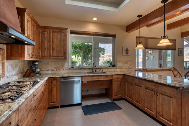 kitchen featuring wall chimney exhaust hood, a wealth of natural light, sink, and appliances with stainless steel finishes